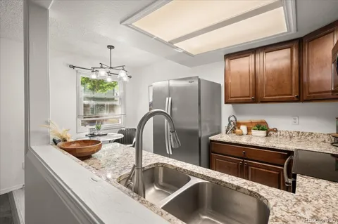 a kitchen with a refrigerator and a sink