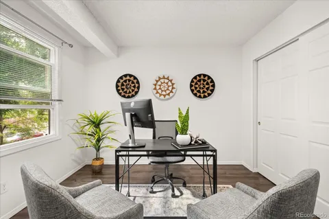 a view of a workspace room with wooden floor and dining table