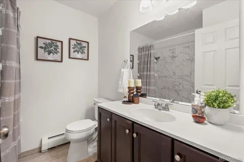 a bathroom with a sink a toilet and mirror