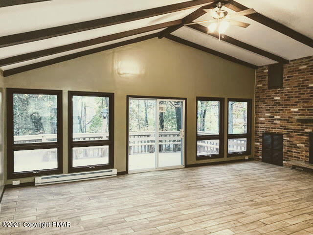 285 Powder Horn Road Henryville, PA 18332 - Photo 8 of 24 a view of an empty room with a window and a fireplace