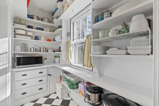 a kitchen with a cabinets and a stove with wooden floor