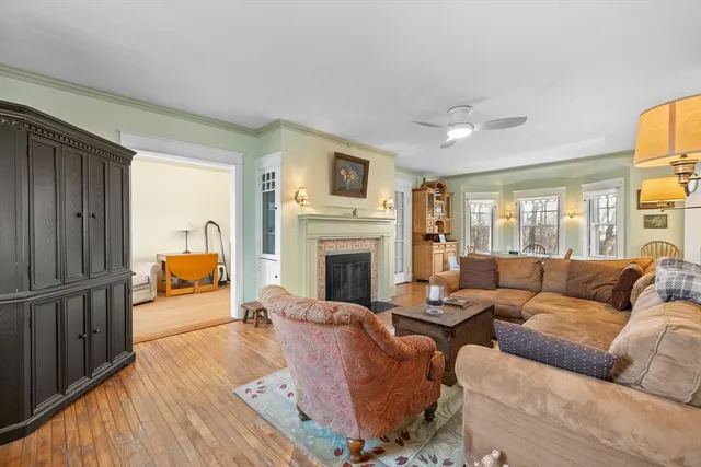 a living room with furniture fireplace and a window