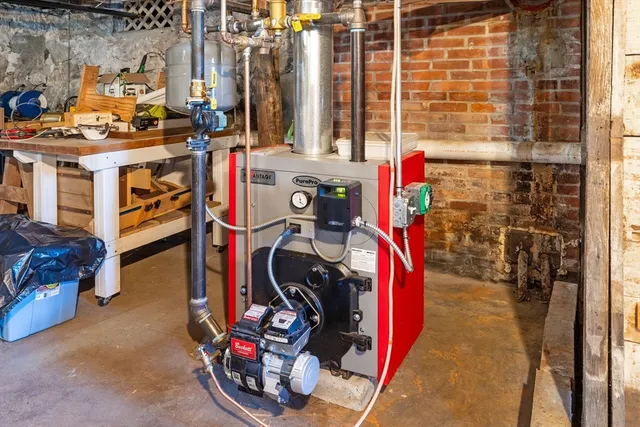 a view of an empty room with wooden floor and windows