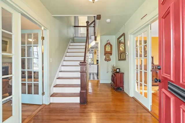 a view of a hallway with wooden floor and windows