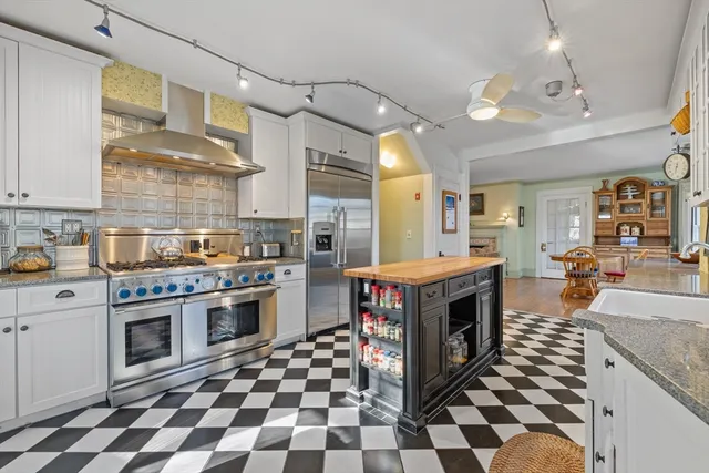 a kitchen with a stove a sink and a refrigerator