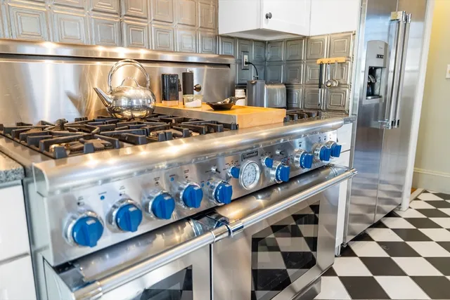 a stove top oven sitting inside of a kitchen