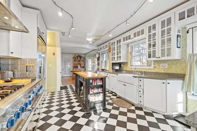 a kitchen with stainless steel appliances granite countertop a sink and cabinets