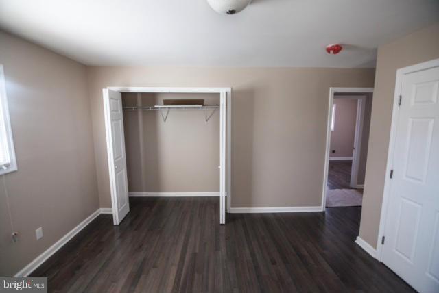 3323 Southgreen Road Baltimore, MD 21244 - Photo 13 of 25 an empty room with wooden floor and closet