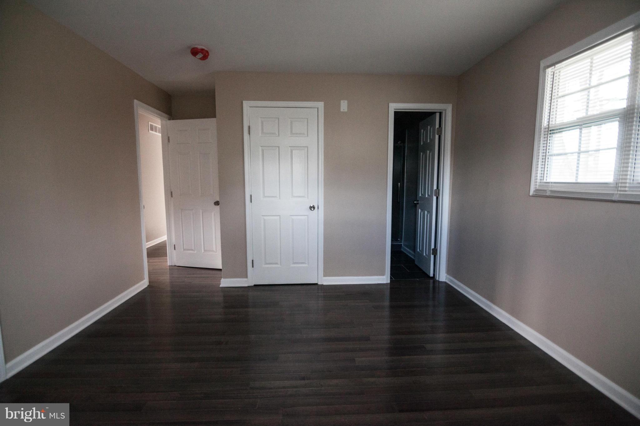3323 Southgreen Road Baltimore, MD 21244 - Photo 14 of 25 a view of an empty room with wooden floor and a window