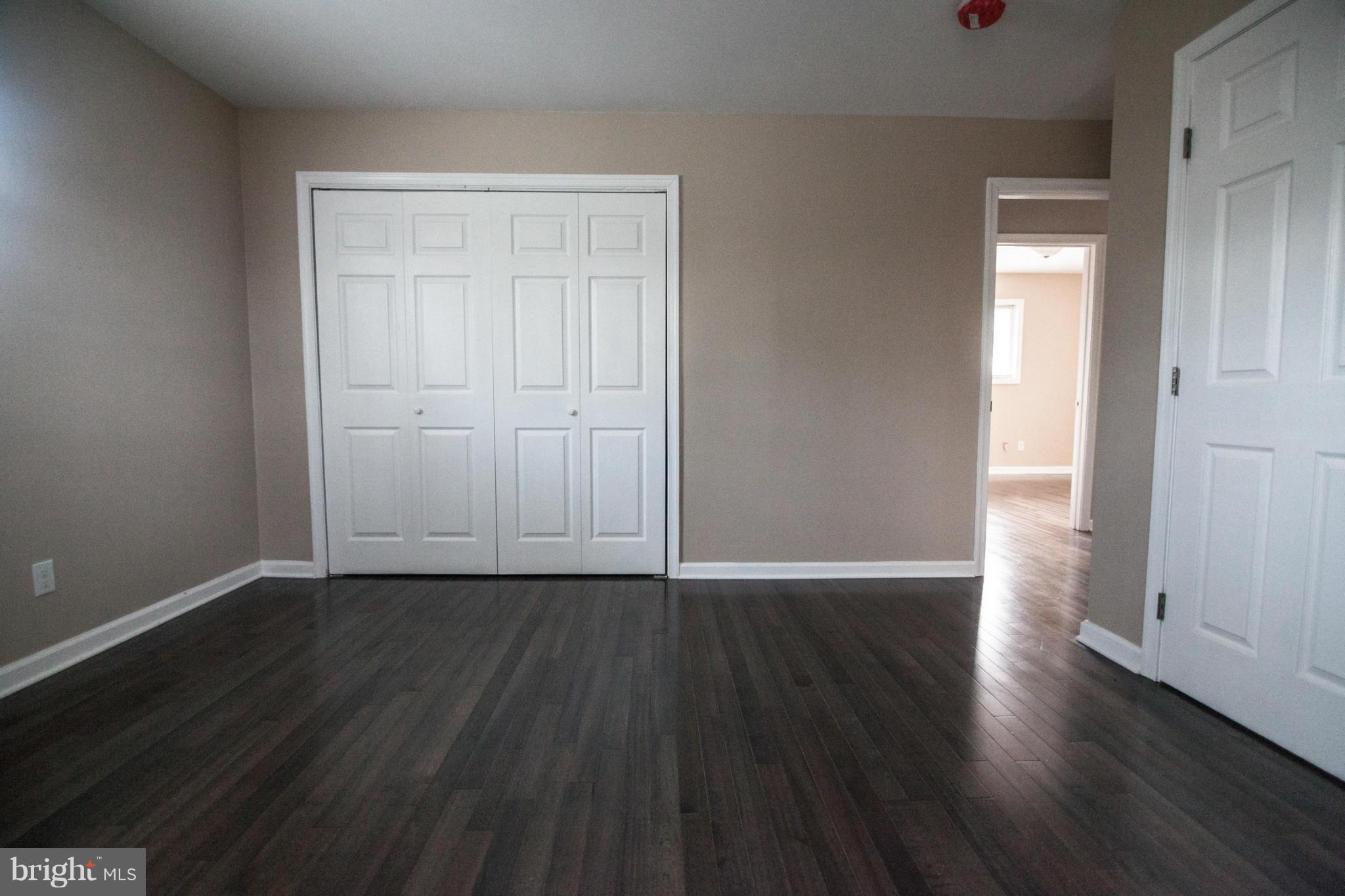 3323 Southgreen Road Baltimore, MD 21244 - Photo 17 of 25 a view of an empty room with wooden floor and closet