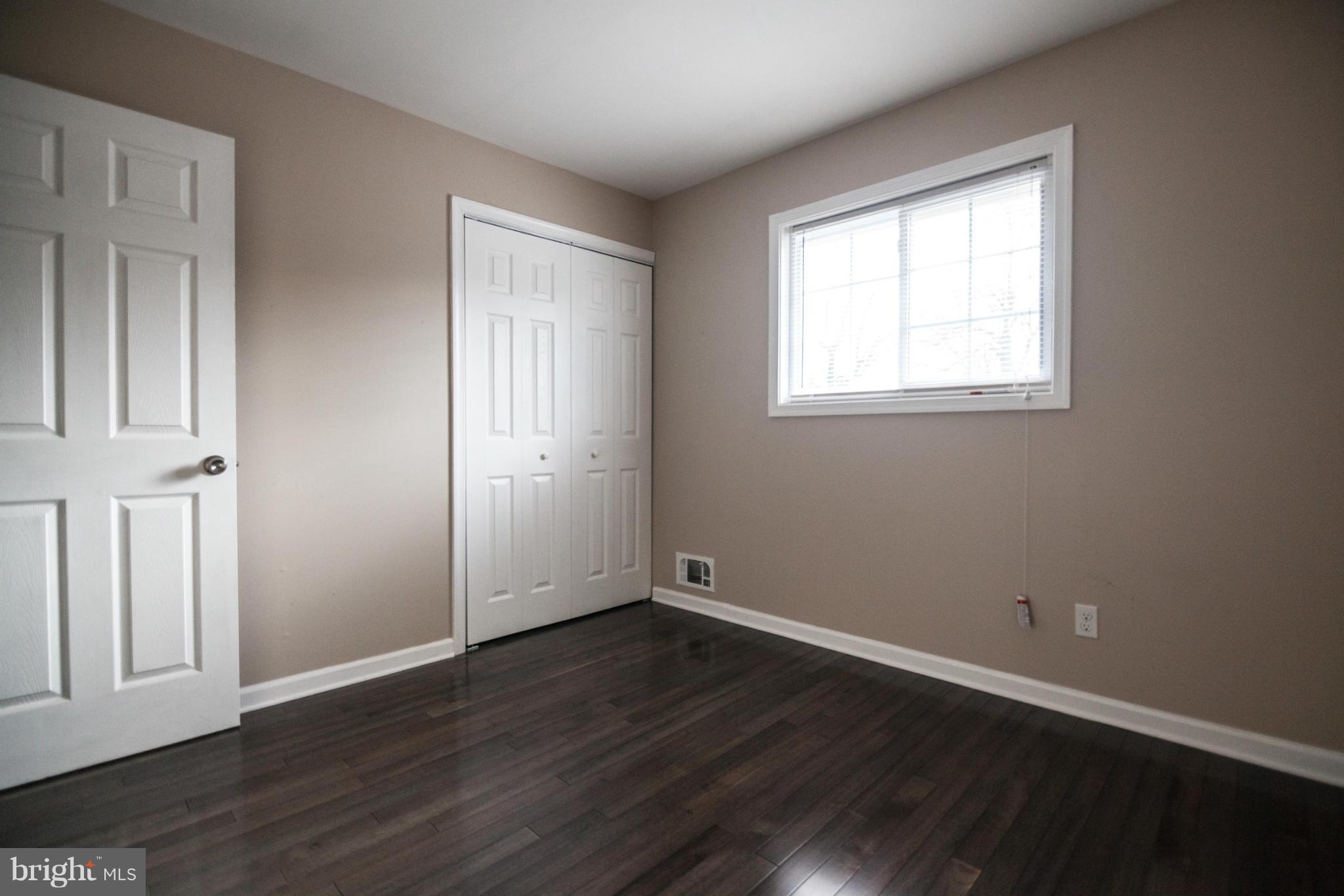 3323 Southgreen Road Baltimore, MD 21244 - Photo 18 of 25 an empty room with wooden floor and windows