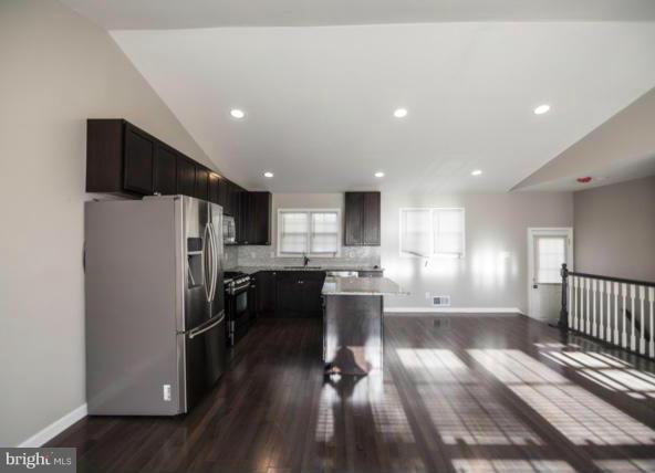3323 Southgreen Road Baltimore, MD 21244 - Photo 5 of 25 a kitchen with a refrigerator a sink and wooden floor
