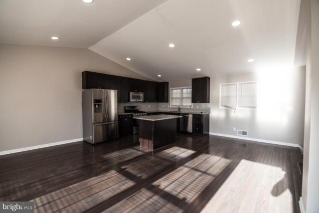 3323 Southgreen Road Baltimore, MD 21244 - Photo 6 of 25 a kitchen with stainless steel appliances kitchen island granite countertop a refrigerator and a stove top oven
