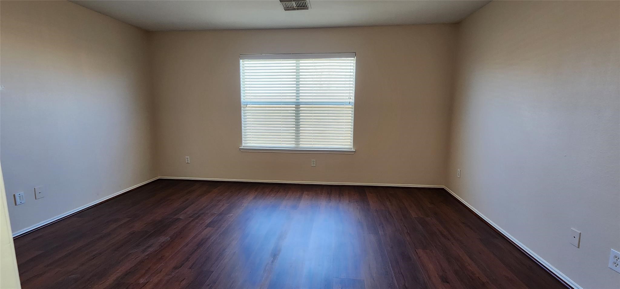 315 Sunset Colony Drive Rosharon, TX 77583 - Photo 11 of 20 an empty room with wooden floor and windows