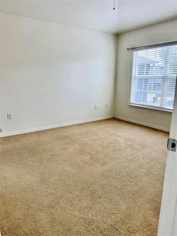 6404 South Goldenrod Road, Unit 2A Orlando, FL 32822 - Photo 28 of 40 an empty room with windows