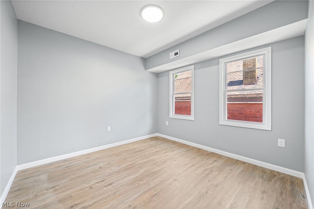 3925 Riverside Avenue Cleveland, OH 44109 - Photo 28 of 48 Room with wood-finish flooring, light grey walls, and white trim
