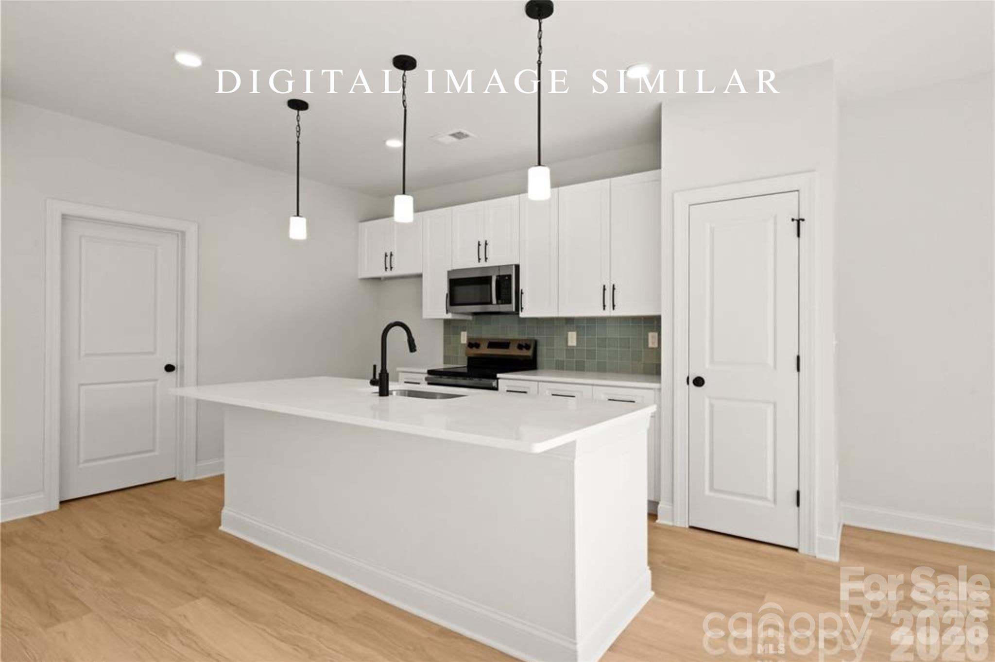 2928 Mulberry Church Road Charlotte, NC 28208 - Photo 35 of 43 a kitchen with stainless steel appliances a stove a sink a white cabinets and a refrigerator