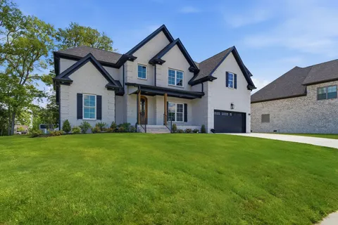a front view of a house with a yard and garage
