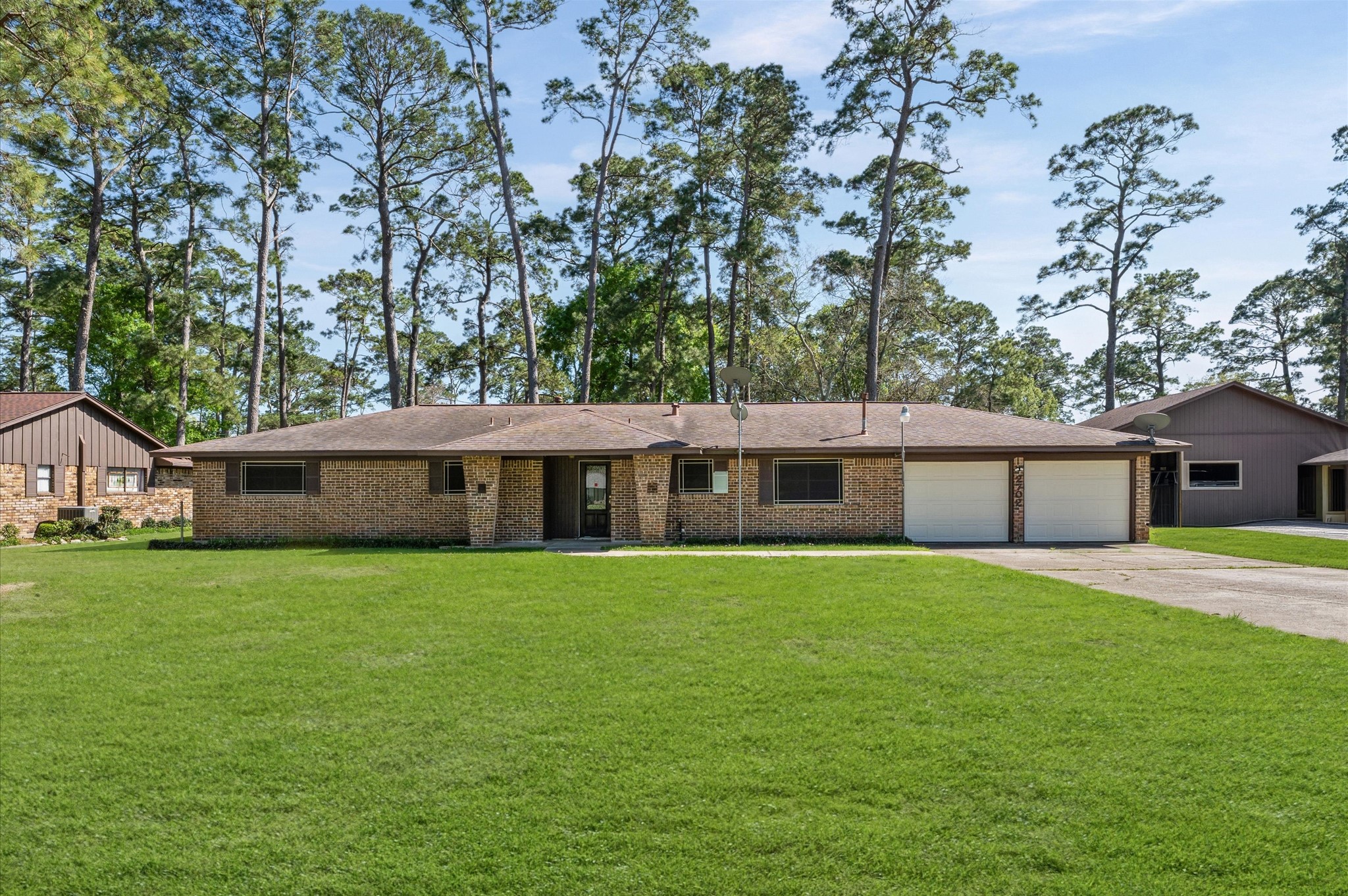 2702 Crowell Lane Baytown, TX 77521 - Photo 1 of 26 a front view of a house with a garden