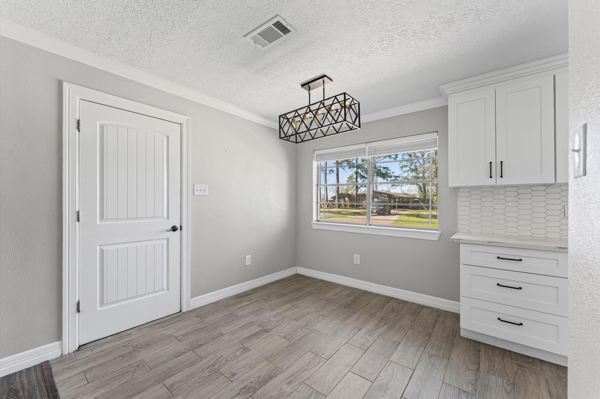 2702 Crowell Lane Baytown, TX 77521 - Photo 11 of 26 wooden floor in an empty room with a window