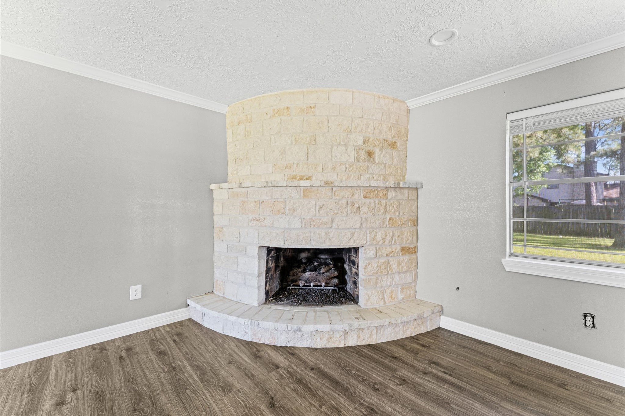 2702 Crowell Lane Baytown, TX 77521 - Photo 12 of 26 a living room with a fireplace and a window