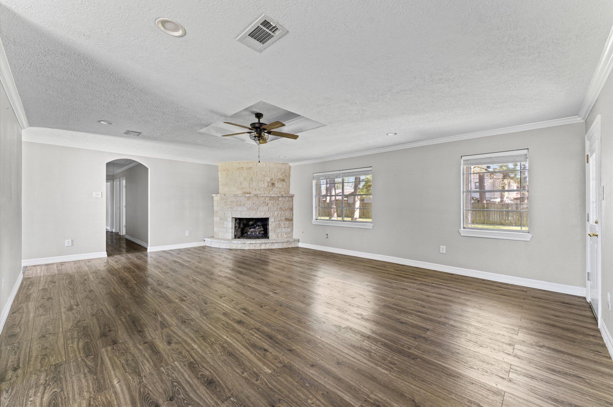 2702 Crowell Lane Baytown, TX 77521 - Photo 13 of 26 a view of an empty room with a window and wooden floor