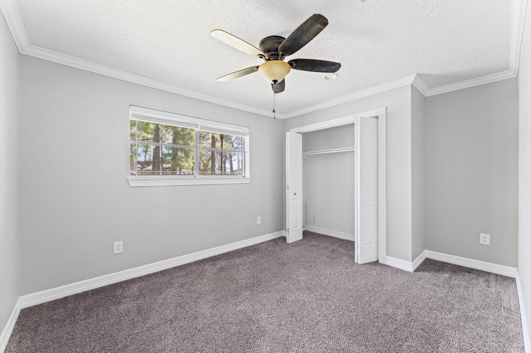 2702 Crowell Lane Baytown, TX 77521 - Photo 15 of 26 a view of an empty room with a ceiling fan and a window