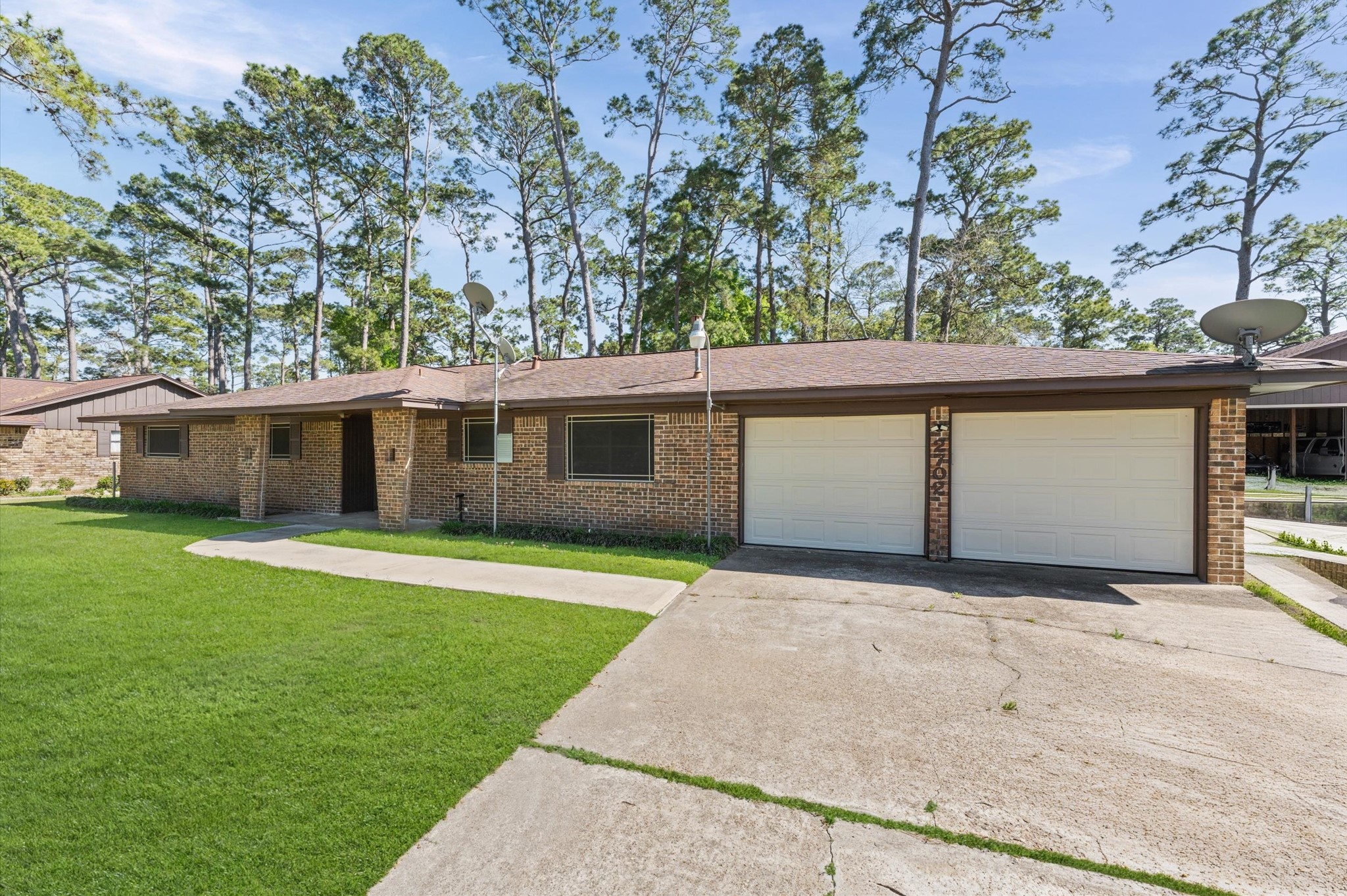 2702 Crowell Lane Baytown, TX 77521 - Photo 3 of 26 a front view of house with yard and trees in the background