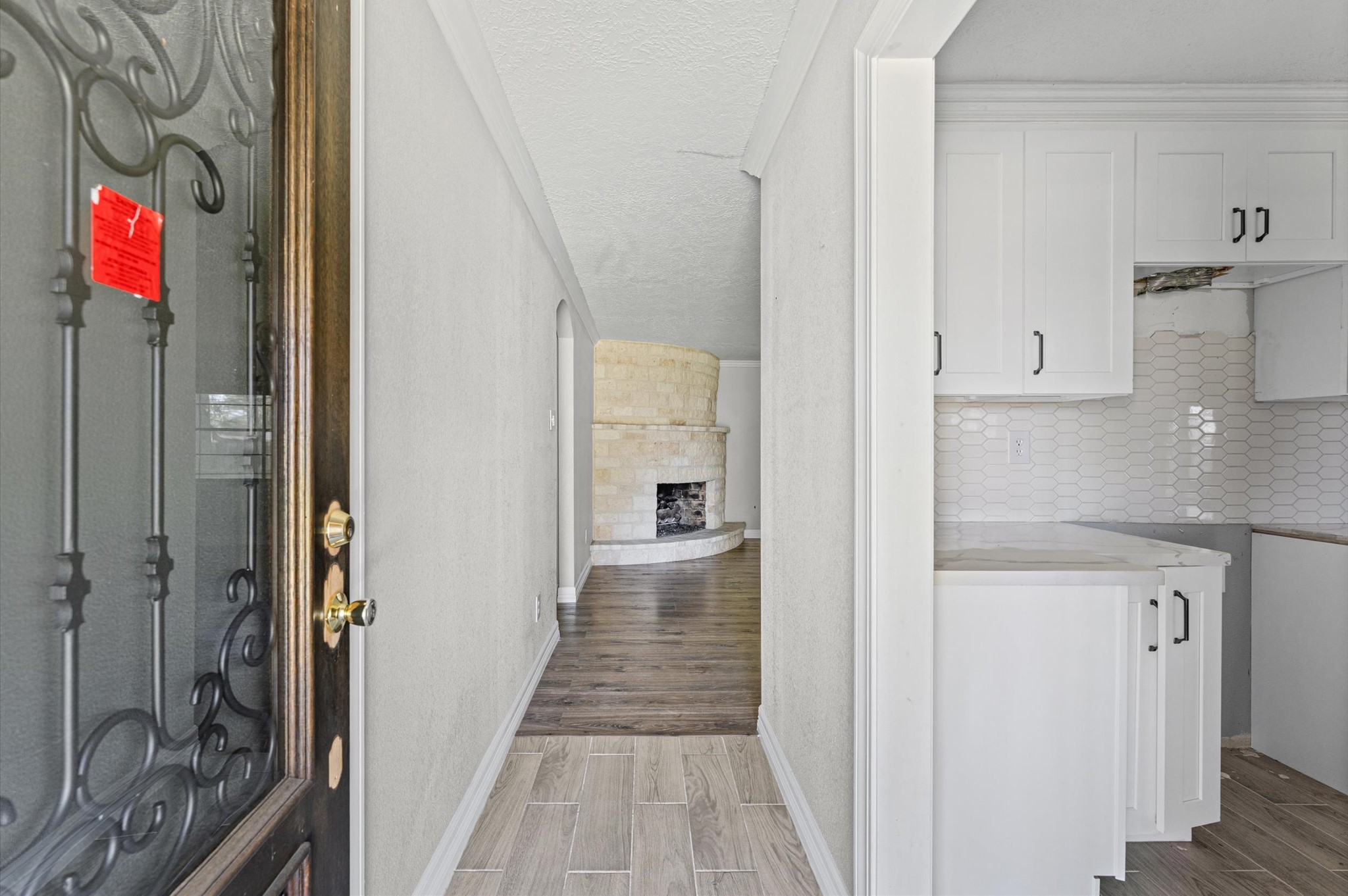 2702 Crowell Lane Baytown, TX 77521 - Photo 5 of 26 a view of a hallway with wooden floor and staircase