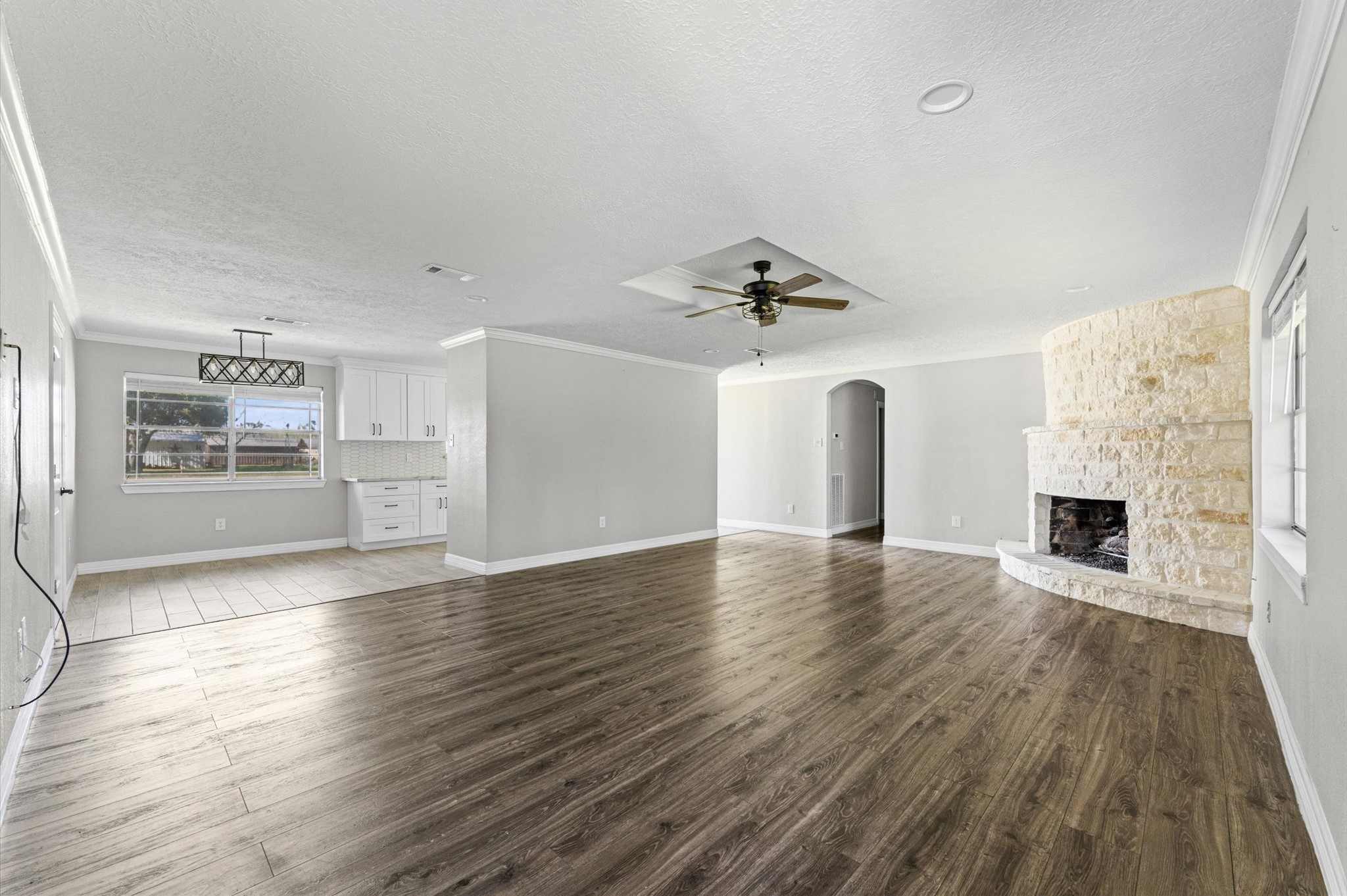 2702 Crowell Lane Baytown, TX 77521 - Photo 7 of 26 a view of empty room with wooden floor and fireplace