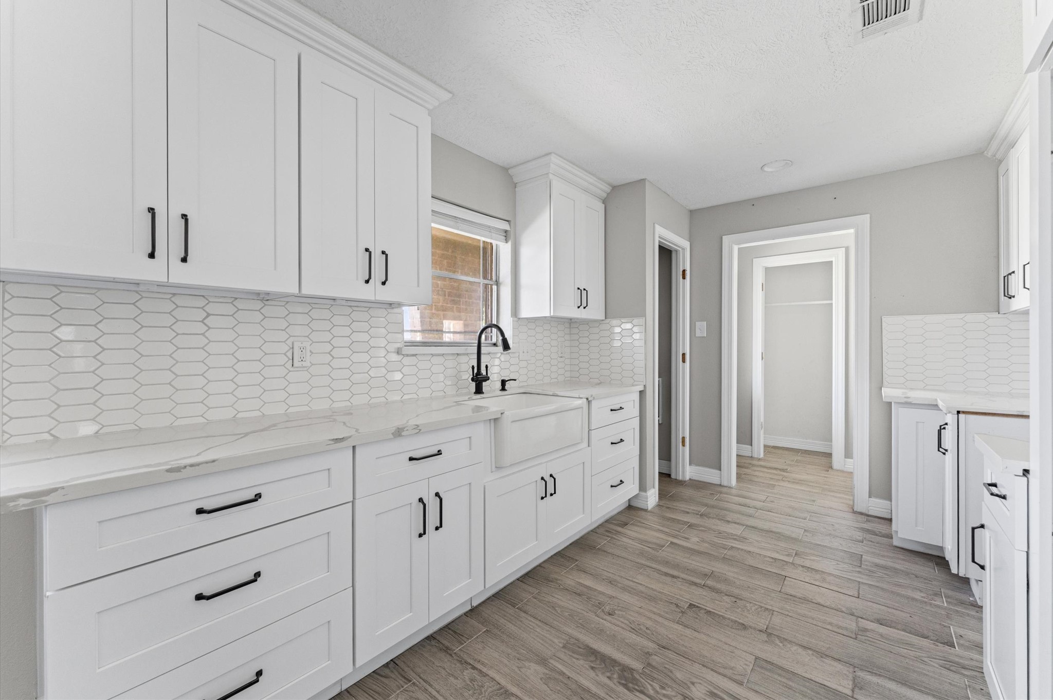 2702 Crowell Lane Baytown, TX 77521 - Photo 8 of 26 a kitchen with white cabinets and sink