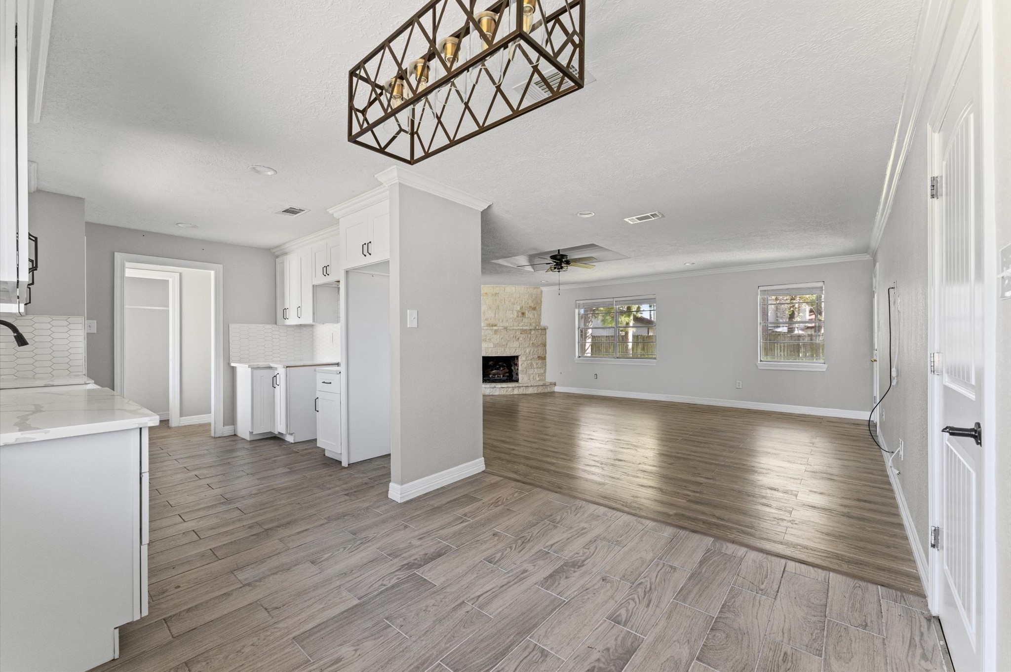 2702 Crowell Lane Baytown, TX 77521 - Photo 9 of 26 a view of a hallway with wooden floor and a kitchen