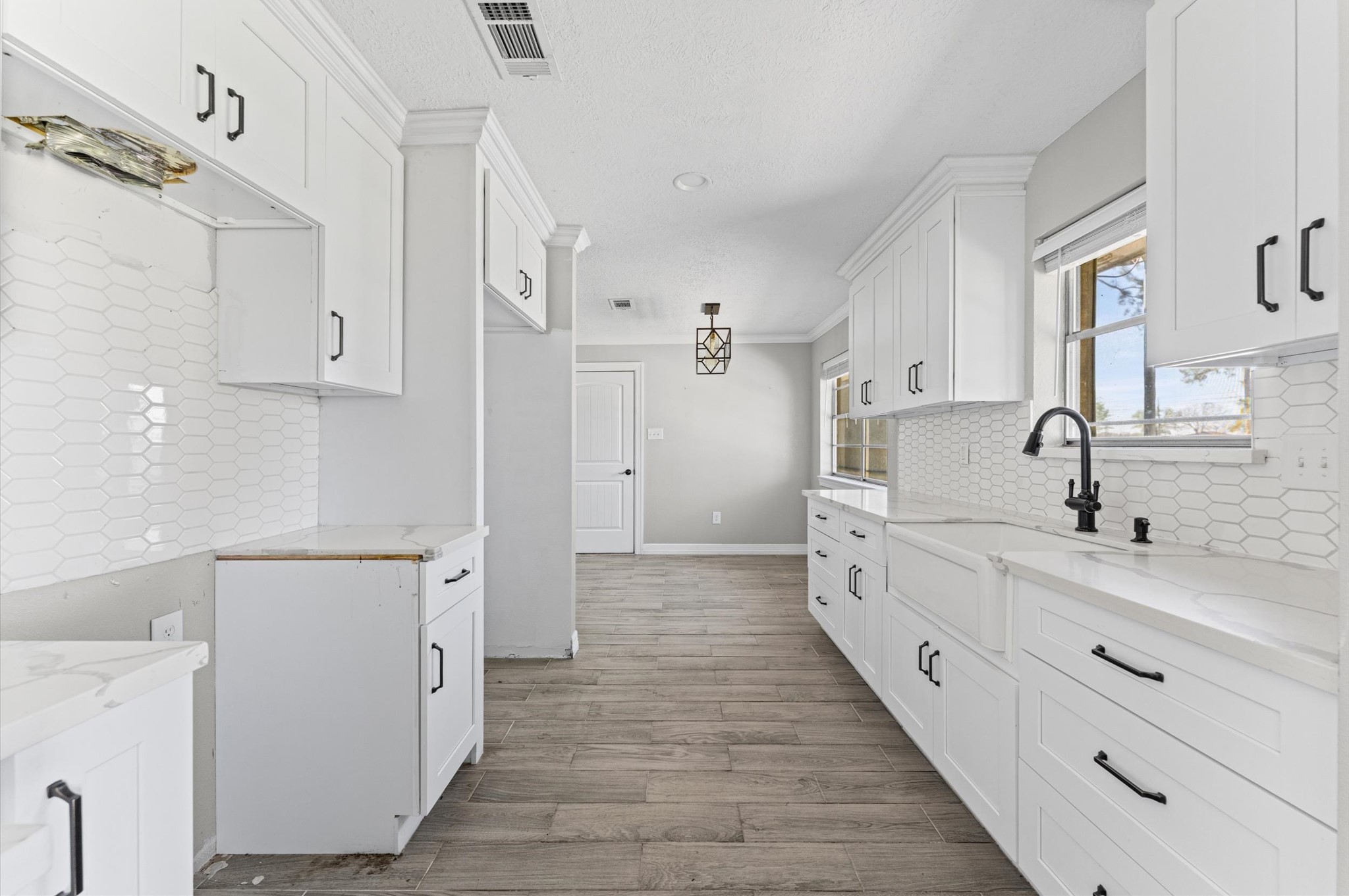 2702 Crowell Lane Baytown, TX 77521 - Photo 10 of 26 a large white kitchen with a sink a refrigerator and a stove