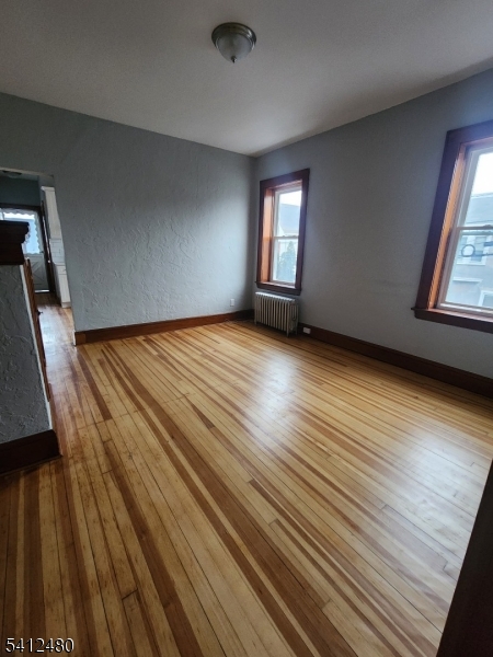 656 Summer Street, Unit 2 Elizabeth, NJ 07202 - Photo 2 of 10 a view of an empty room with wooden floor and a window