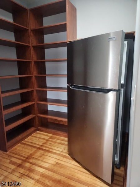 656 Summer Street, Unit 2 Elizabeth, NJ 07202 - Photo 5 of 10 a view of empty room with wooden floor and cabinet