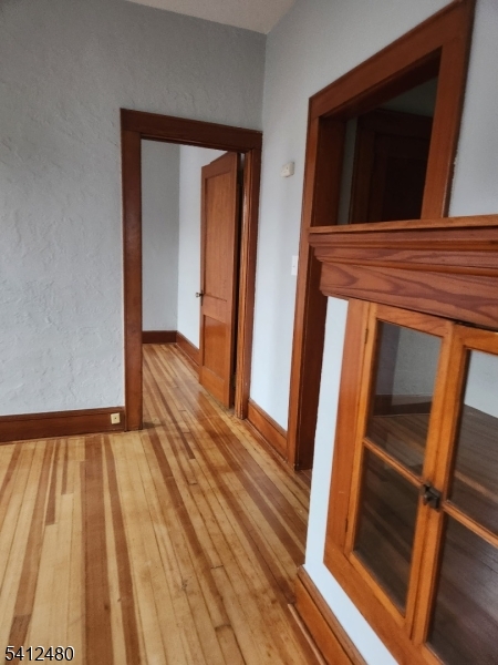 656 Summer Street, Unit 2 Elizabeth, NJ 07202 - Photo 7 of 10 a view of an empty room with wooden floor and a window