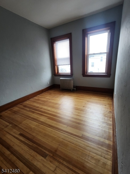 656 Summer Street, Unit 2 Elizabeth, NJ 07202 - Photo 10 of 10 an empty room with wooden floor and windows