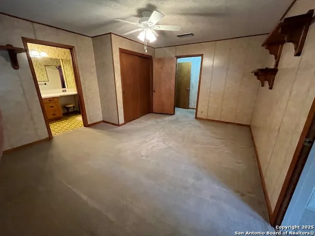 a living room with furniture and a ceiling fan
