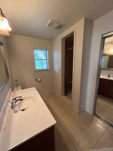 a room with a open cabinet and a flat screen tv