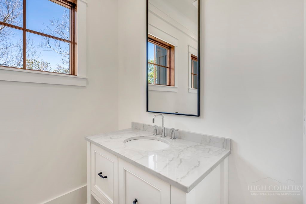536 Boone Ridge Lane Boone, NC 28607 - Photo 23 of 50 a bathroom with a granite countertop sink and a mirror
