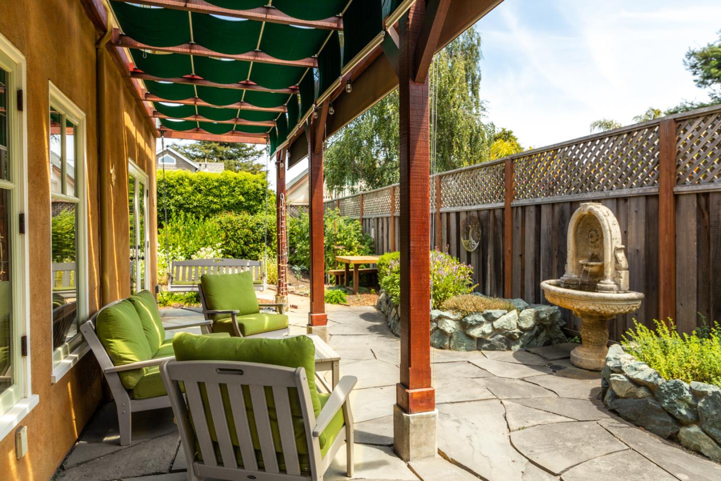 508 Oak Drive Capitola, CA 95010 - Photo 19 of 31 a view of a patio with table and chairs potted plants with wooden floor and fence