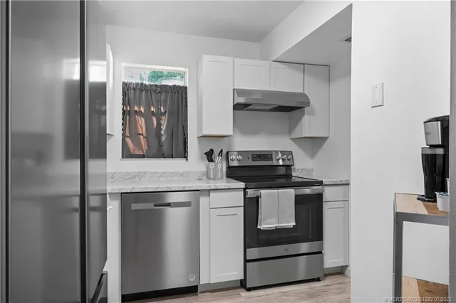 a kitchen with a stove and a refrigerator