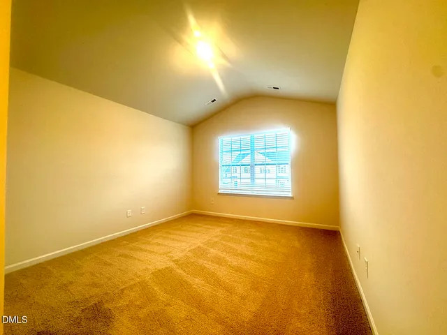 an empty room with a empty space and a window