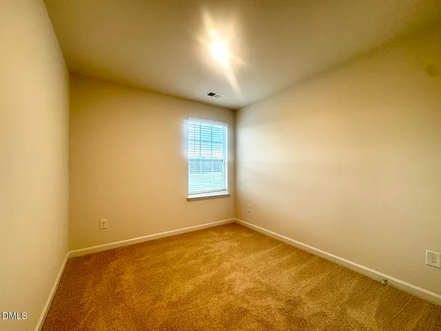 an empty room with closet area