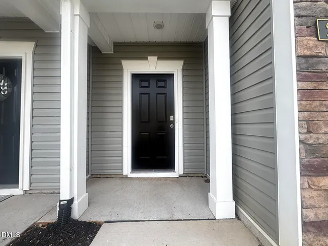 a view of a hallway with wooden floor and stairs