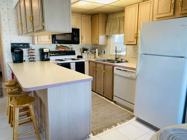 a living room with furniture a ceiling fan and a rug
