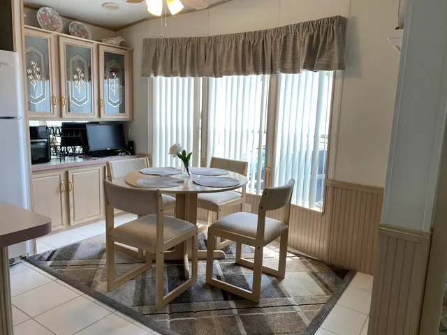 a view of a lake with boats and palm trees