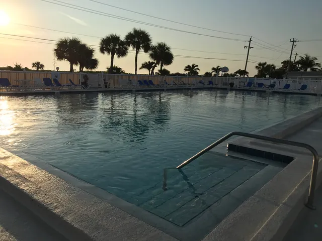 a living room with furniture a rug and kitchen view