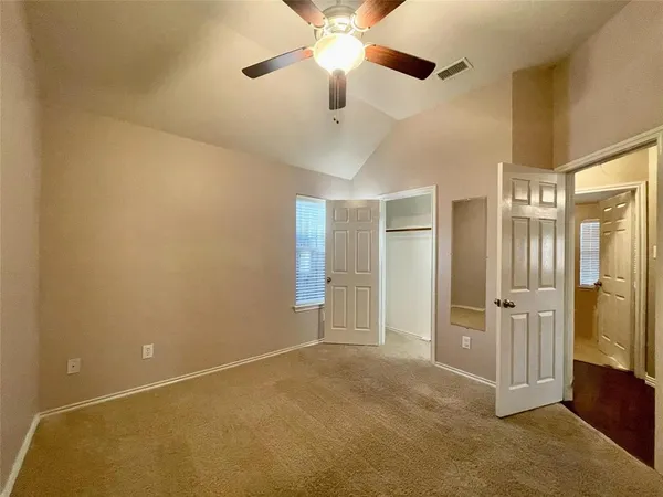 a view of empty room with ceiling fan