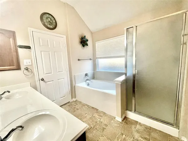 a bathroom with a sink a mirror and a shower